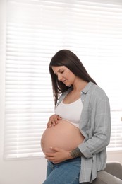 Photo of Portrait of beautiful pregnant woman at home