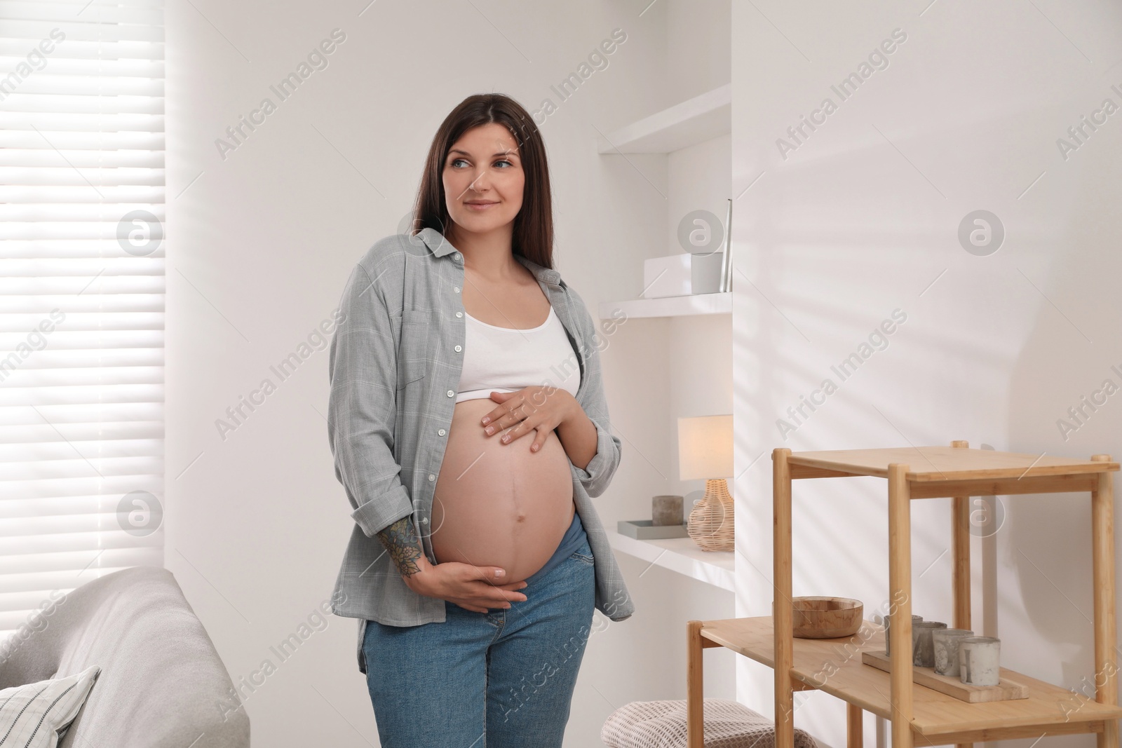 Photo of Portrait of beautiful pregnant woman at home