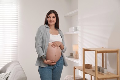 Portrait of beautiful pregnant woman at home