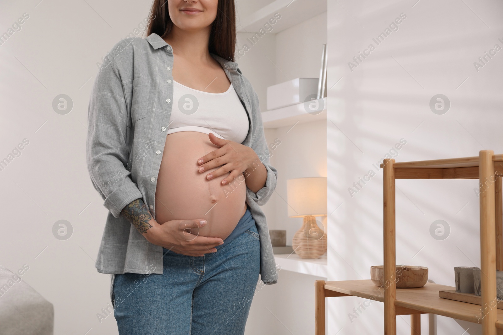 Photo of Pregnant woman in living room, closeup view