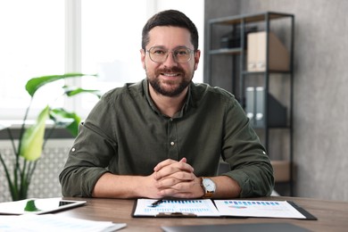 Consultant at table with documents in office