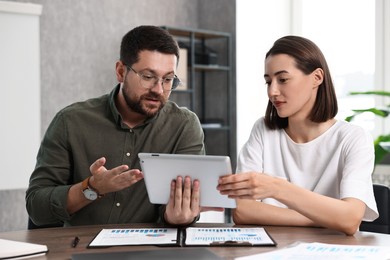 Consultant working with client at table in office