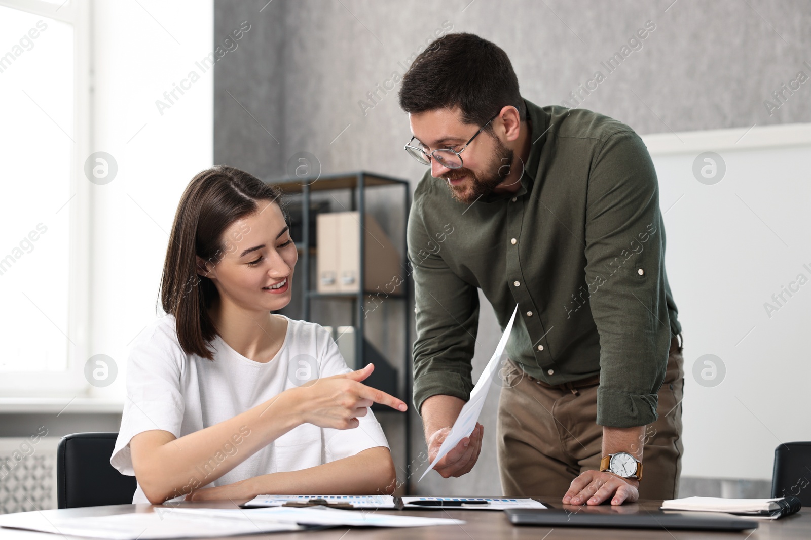 Photo of Consultant working with client at table in office