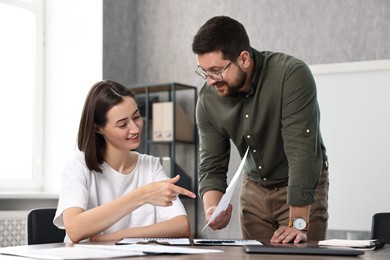 Consultant working with client at table in office