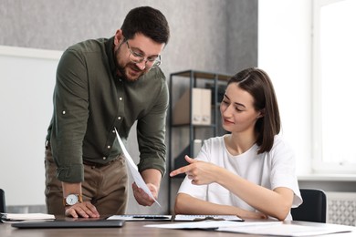 Consultant working with client at table in office