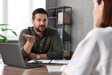 Consultant working with client at table in office