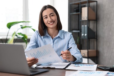 Consultant with document and pen at table in office