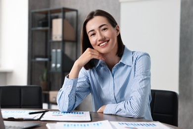 Consultant at table with documents in office