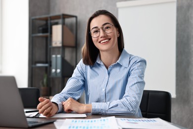 Consultant at table with documents in office