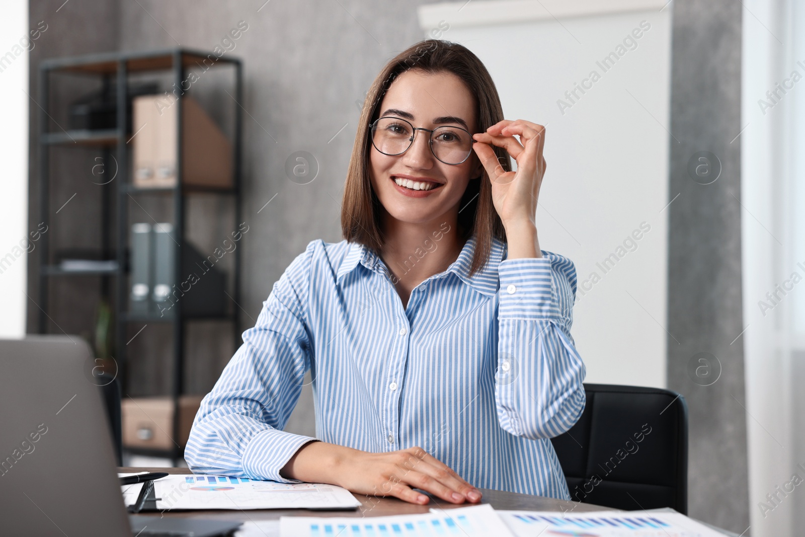 Photo of Consultant at table with documents in office