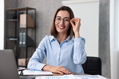 Consultant at table with documents in office