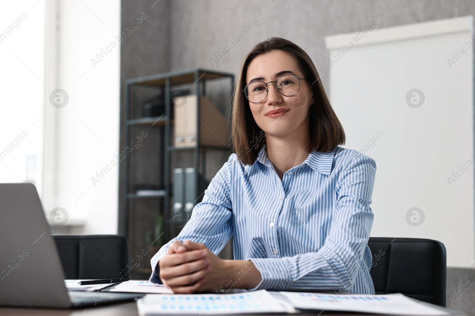 Photo of Consultant at table with documents in office