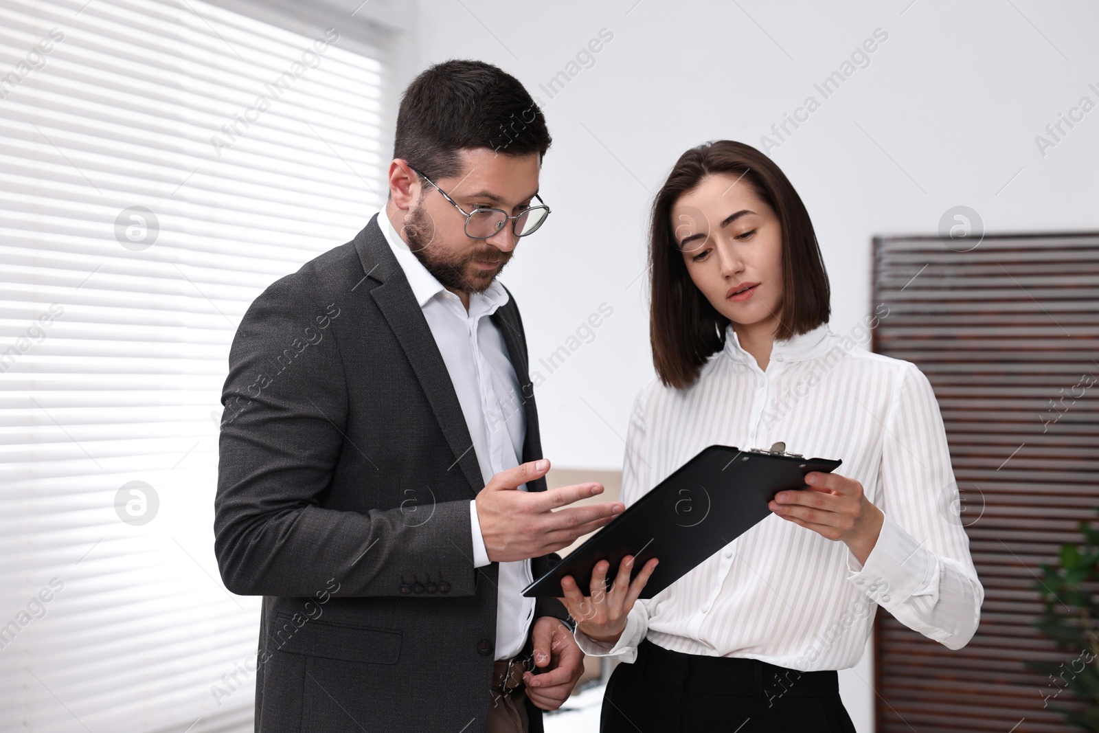 Photo of Young consultant working with client in office