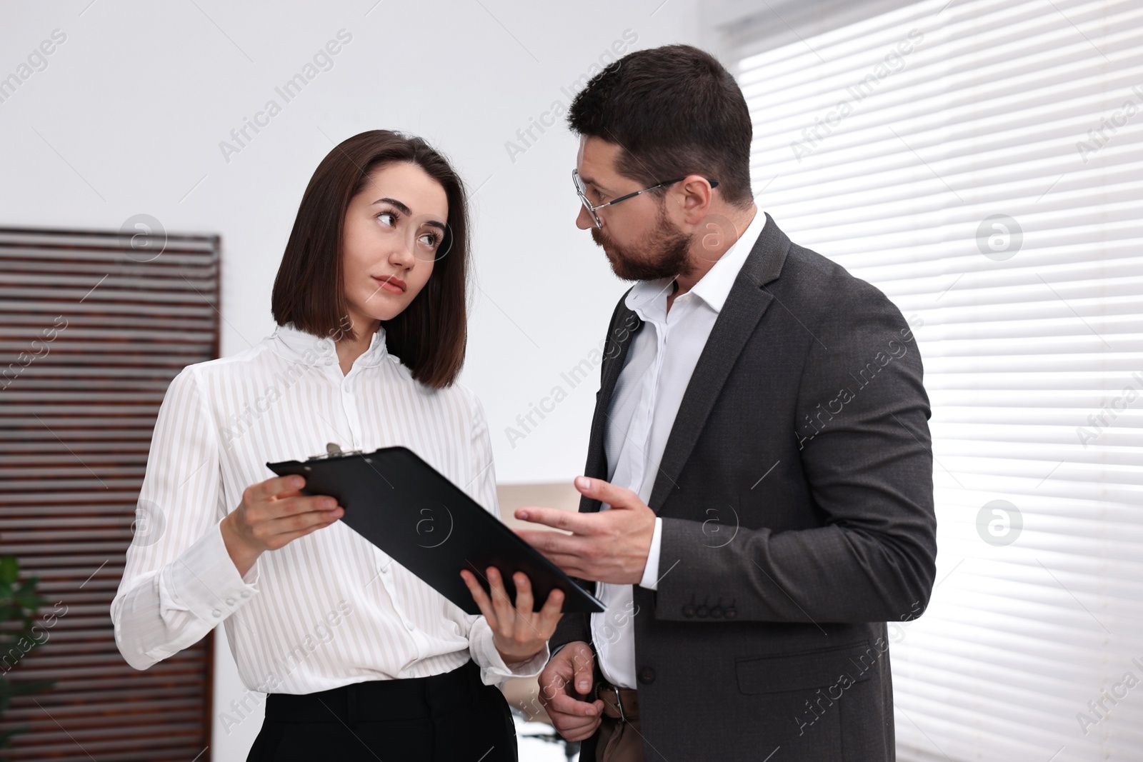 Photo of Young consultant working with client in office