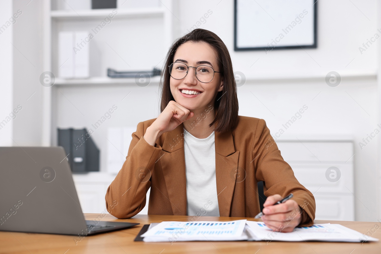 Photo of Consultant working with documents at table in office