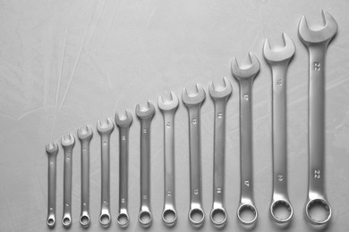 Photo of Auto mechanic's tools on grey table, flat lay