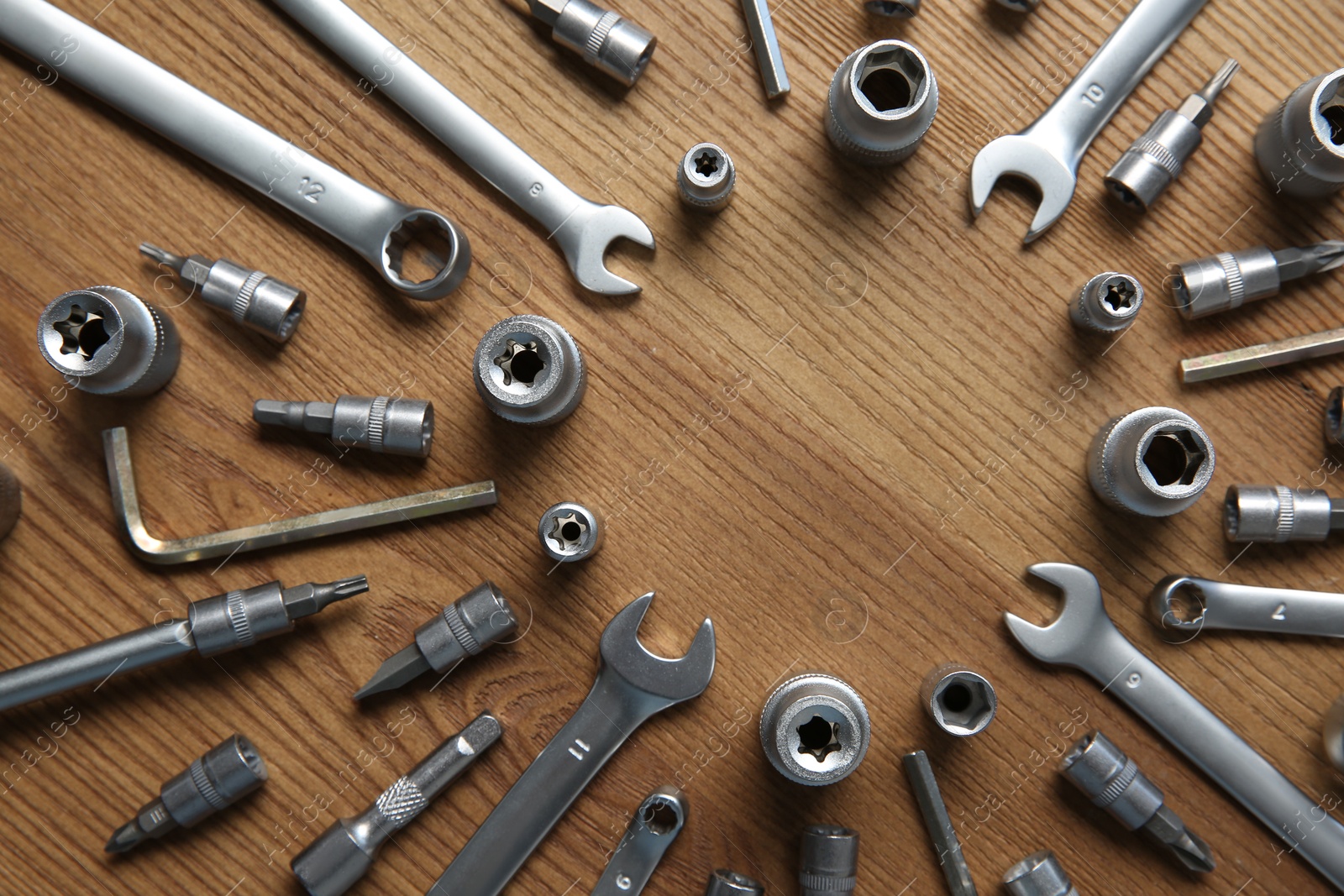 Photo of Different auto mechanic's tools on wooden table, flat lay. Space for text