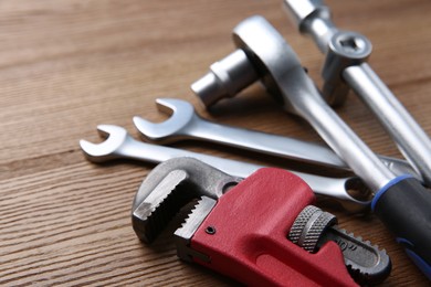 Different auto mechanic's tools on wooden table, closeup