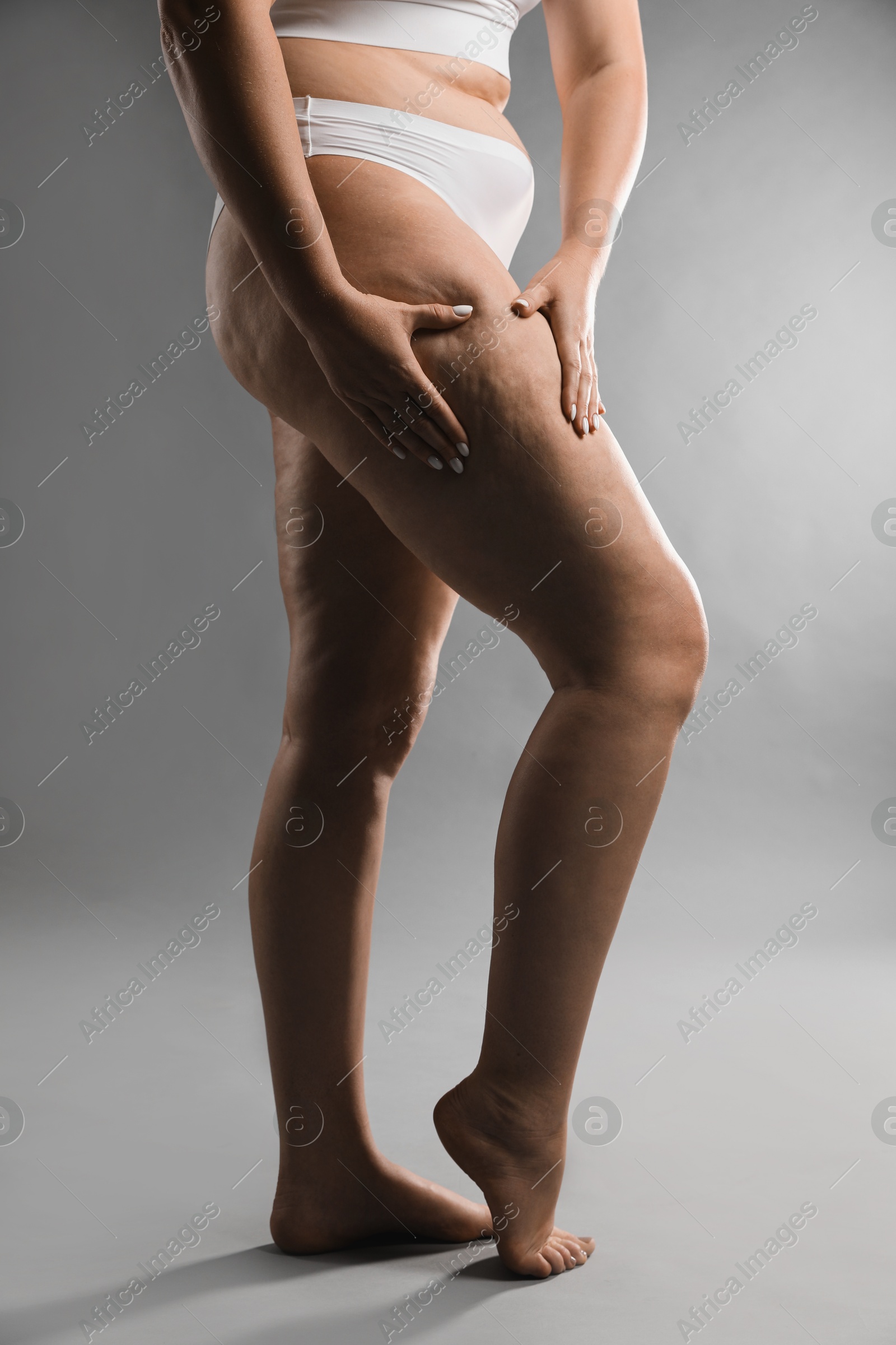 Photo of Woman with cellulite on grey background, closeup