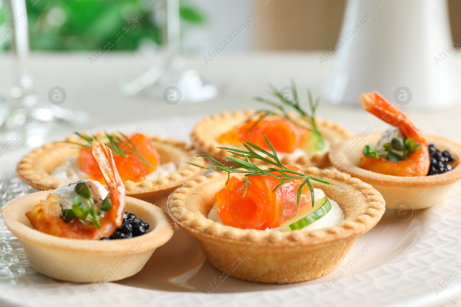 Photo of Delicious canapes with shrimps, salmon and caviar on table, closeup