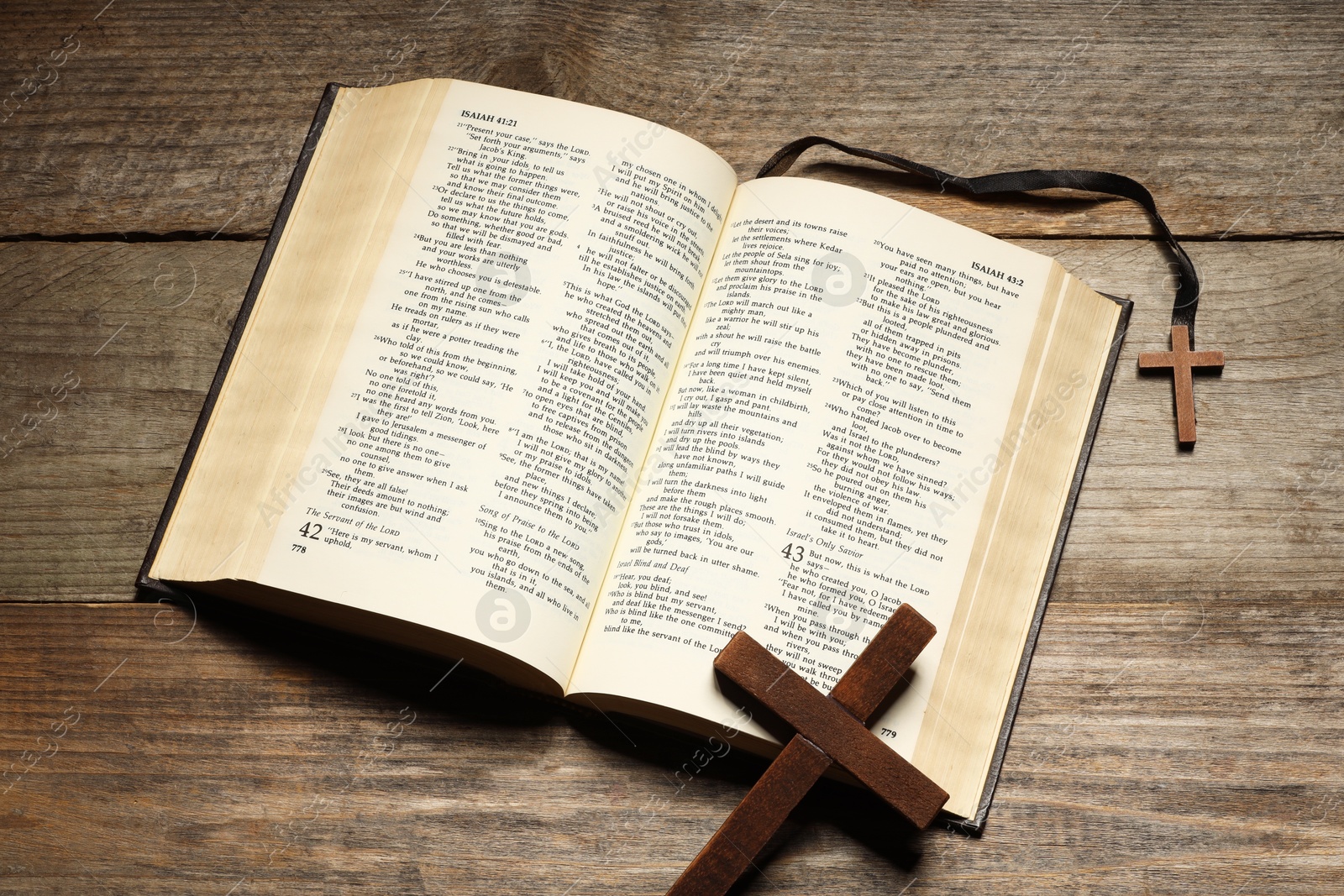 Photo of Bible and crosses on wooden table, top view. Religion of Christianity