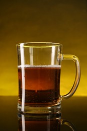 Photo of Glass of beer with froth on dark table, closeup