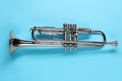 One trumpet on light blue background, top view