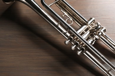 Photo of One trumpet on wooden table, above view