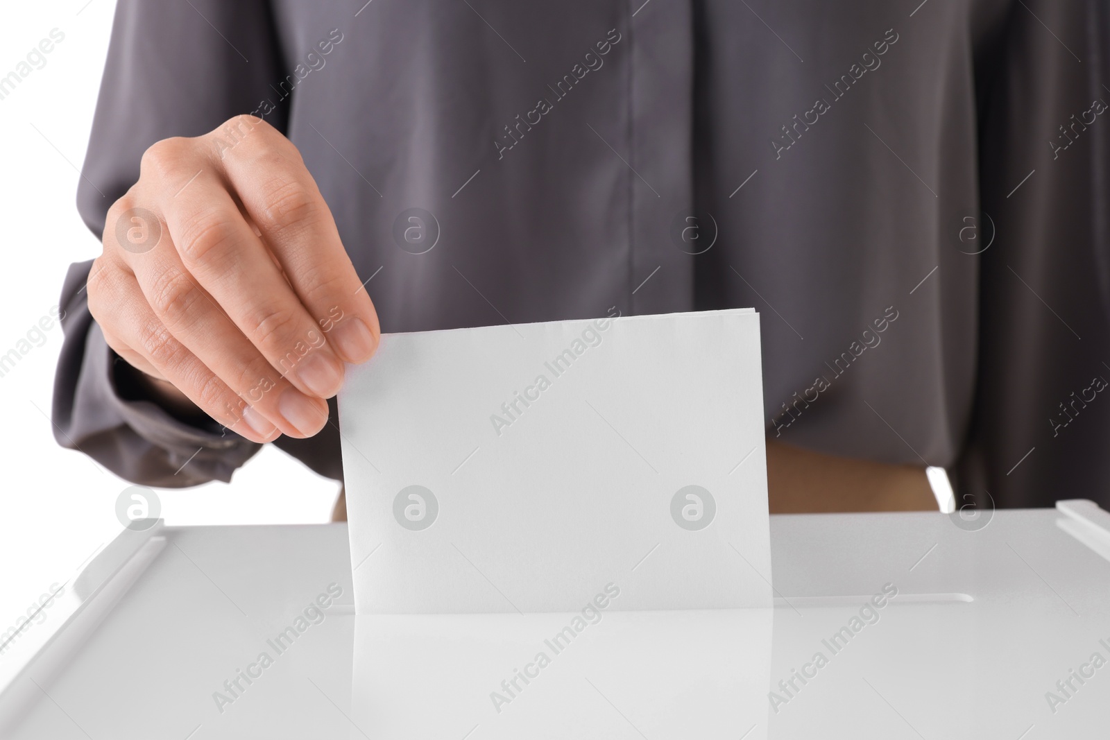 Photo of Woman putting her vote into ballot box against white background, closeup