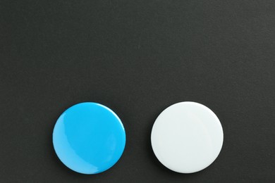 Button badges on black background, flat lay. Mockup for design