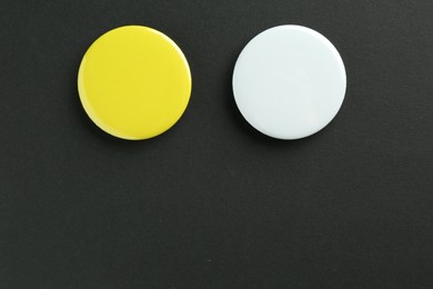 Photo of Button badges on black background, flat lay. Mockup for design