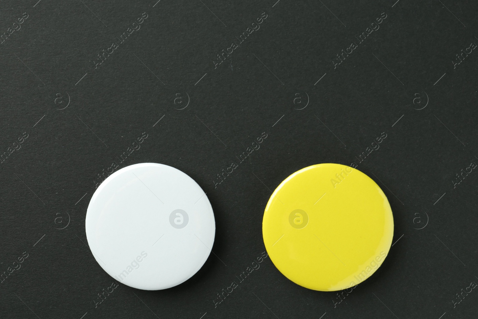 Photo of Button badges on black background, flat lay. Mockup for design