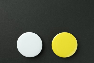 Photo of Button badges on black background, flat lay. Mockup for design