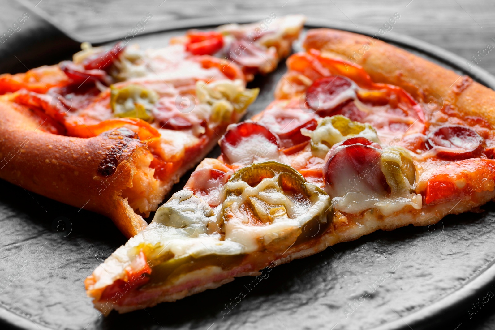 Photo of Board with pieces of delicious pizza Diablo on table, closeup