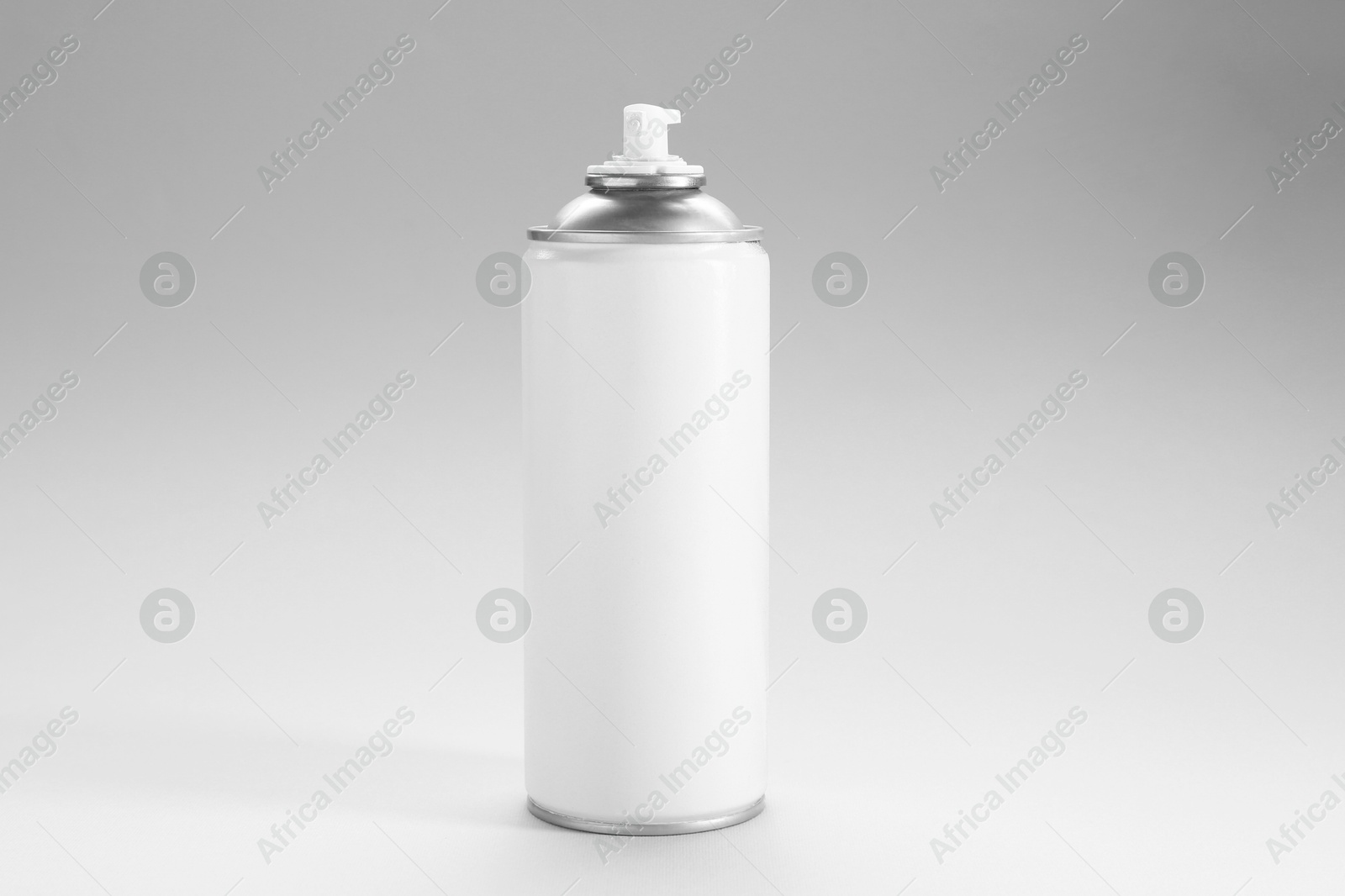 Photo of White spray paint can on gray background