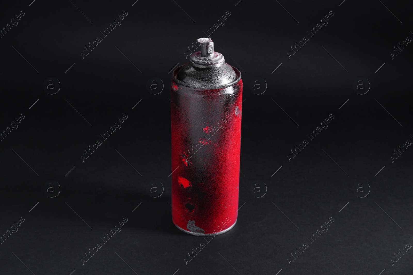 Photo of One spray paint can on dark background