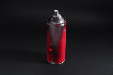 Photo of One spray paint can on dark background