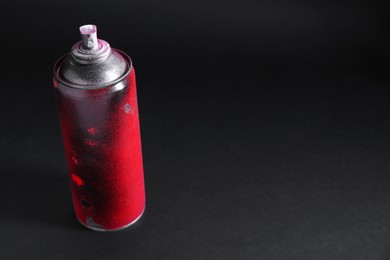 Photo of One spray paint can on dark background, space for text