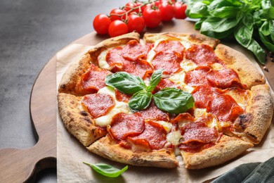 Tasty pepperoni pizza and ingredients on table