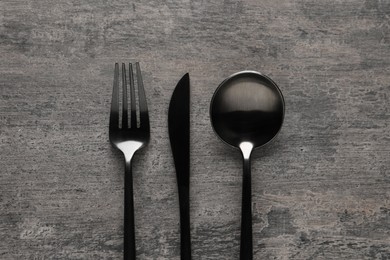 Photo of Stylish cutlery on grey table, flat lay