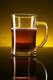 Photo of Glass of beer with froth on dark table, closeup