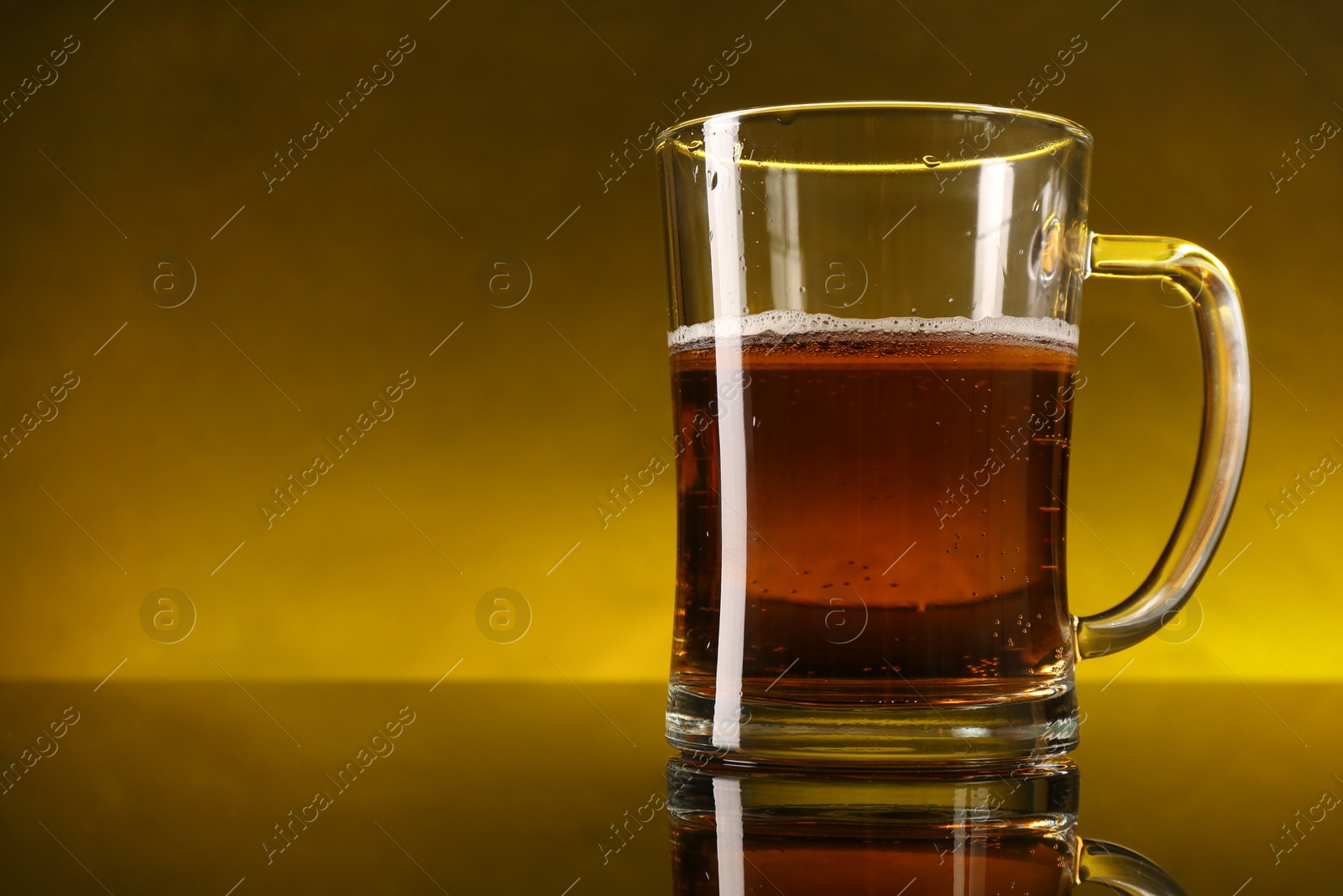 Photo of Glass of beer with froth on dark table, closeup