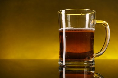 Photo of Glass of beer with froth on dark table, closeup