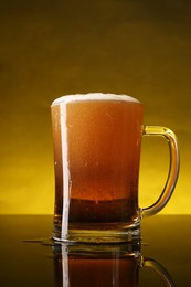 Photo of Glass of beer with froth on dark table, closeup