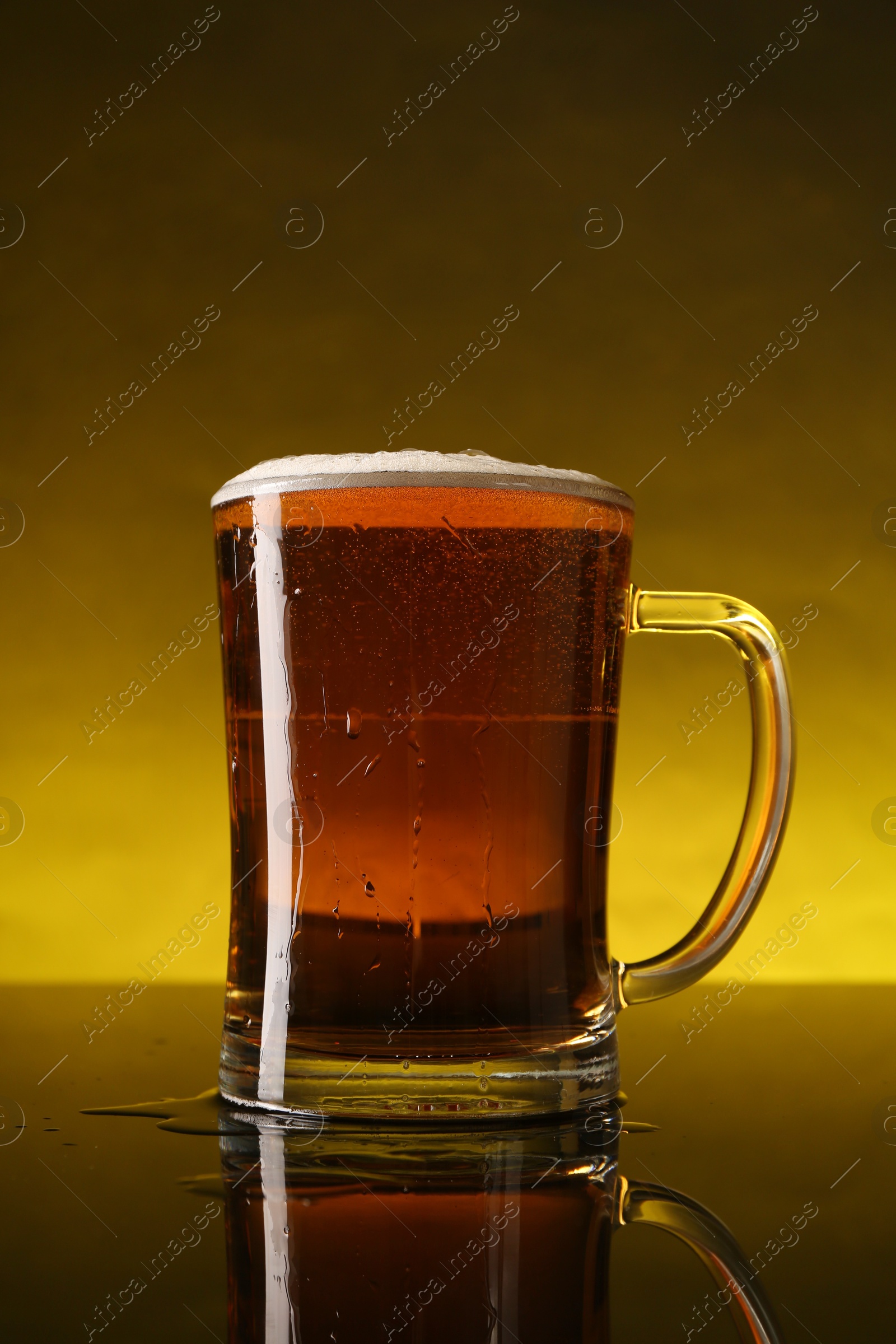 Photo of Glass of beer with froth on dark table, closeup