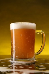 Photo of Glass of beer with froth on dark table, closeup