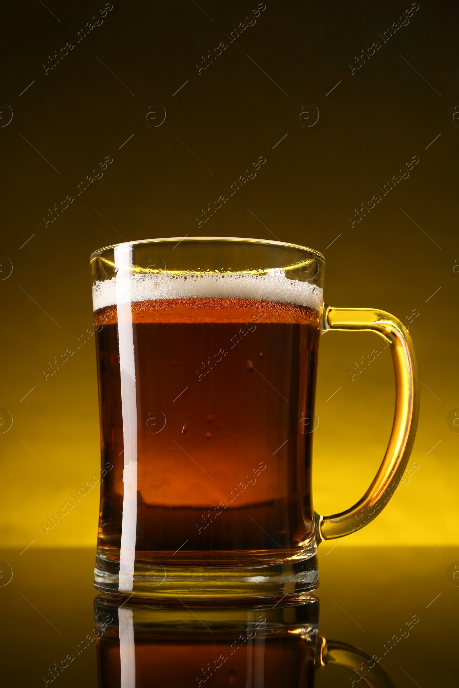 Photo of Glass of beer with froth on dark table, closeup