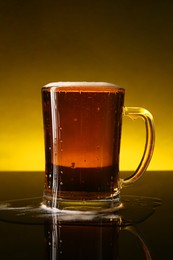 Photo of Glass of beer with froth on dark table, closeup