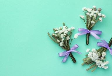 Many stylish boutonnieres on turquoise background, flat lay. Space for text