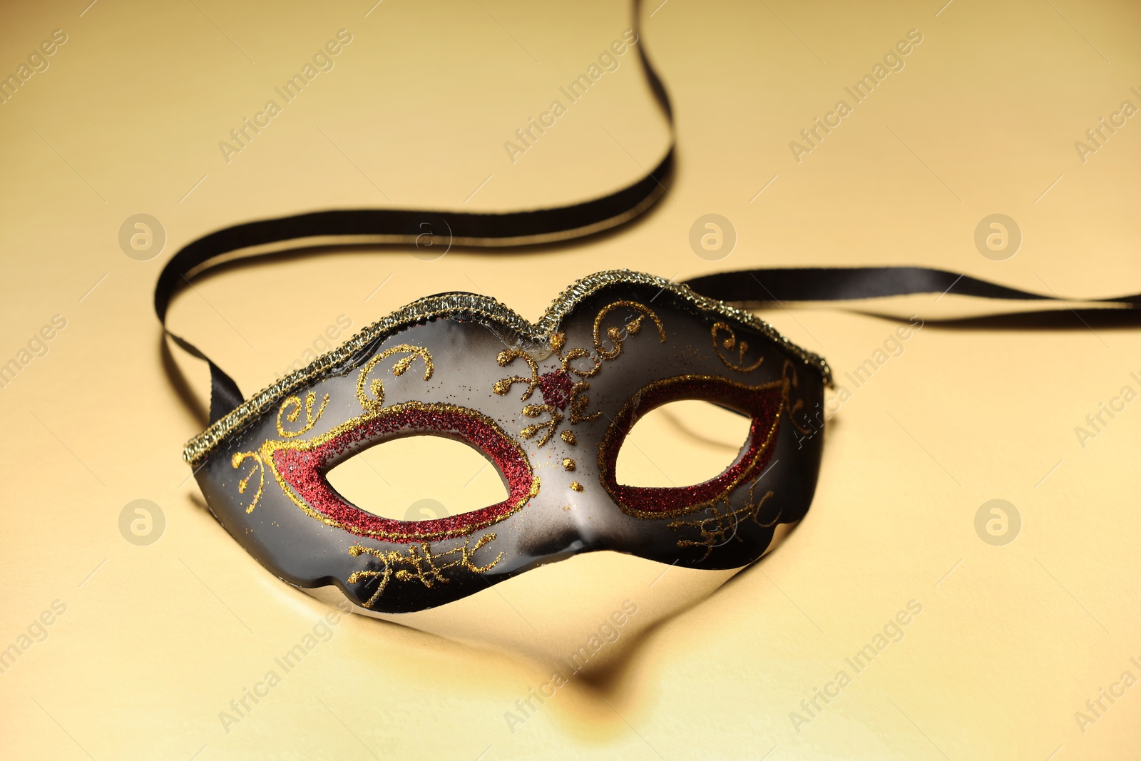 Photo of Elegant face mask on beige background. Theatrical performance